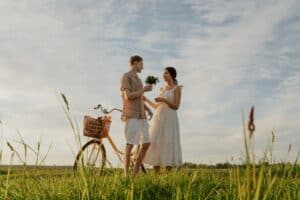 Low-Angle Shot of a Man Giving Flowers to a Woman