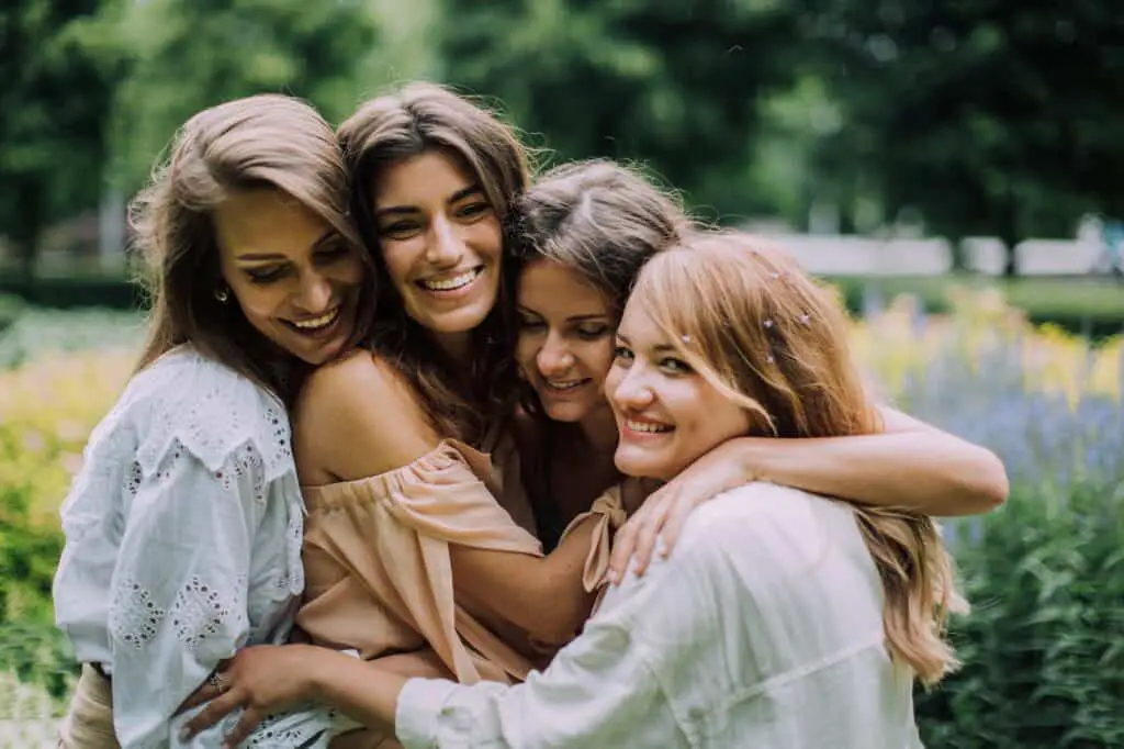 Women Hugging and Smiling