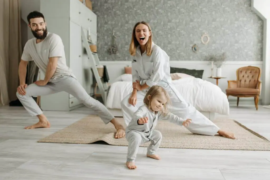 A Couple Stretching Their Legs while Looking at Their Cute Daughter, morning routine