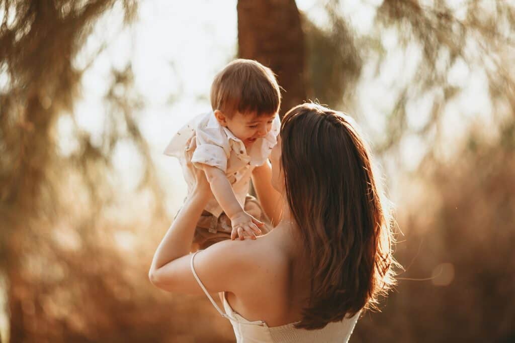 A Woman Carrying a Young Boy