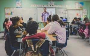 man and woman sitting on chairs, classroom