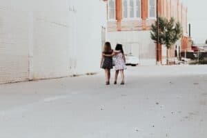 two girls walking on street