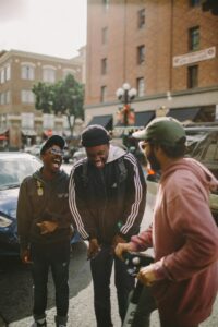 three men in jacket laughing with each other