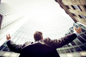 low-angle photography of man in the middle of buildings