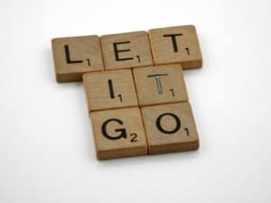 brown wooden blocks with letters on them on white surface