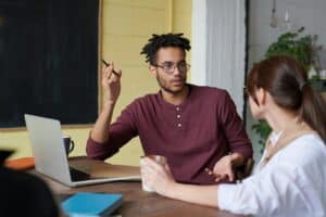 Two colleagues engaged in a collaborative discussion