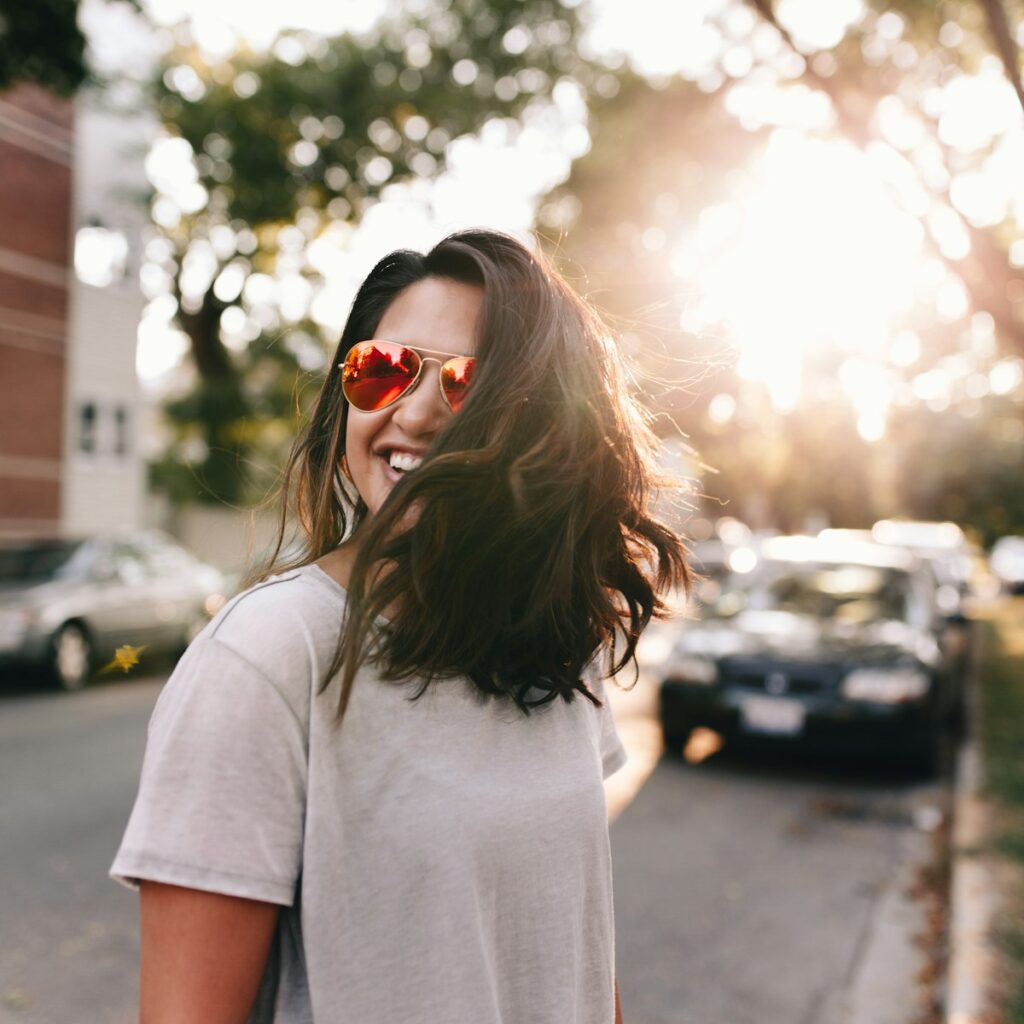 woman wearing white T-shirt smiling and in good mood